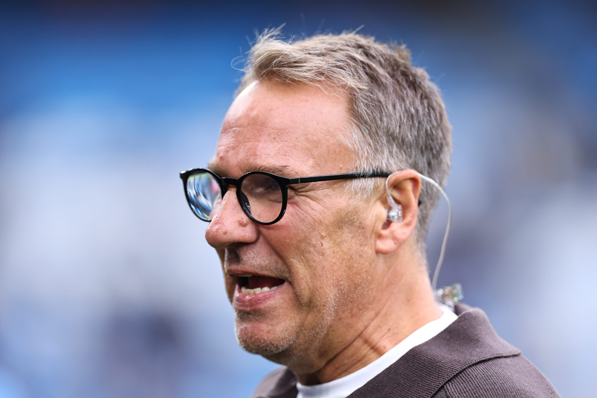 Sky Sports pundit Paul Merson watches on.