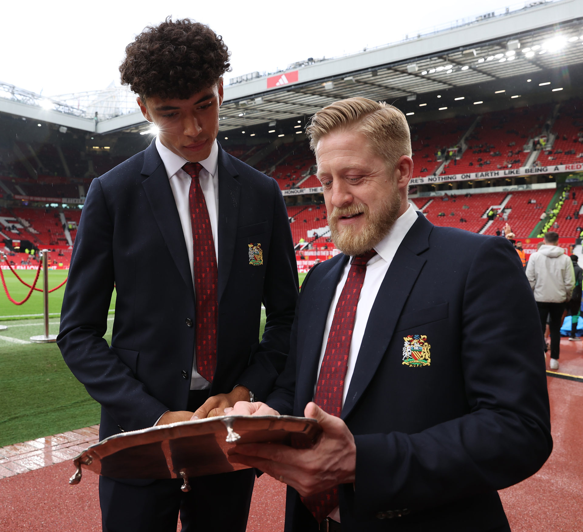 Ethan Wheatley of Manchester United is presented with the Jimmy Murphy Young Player of the Year award by Nick Cox.