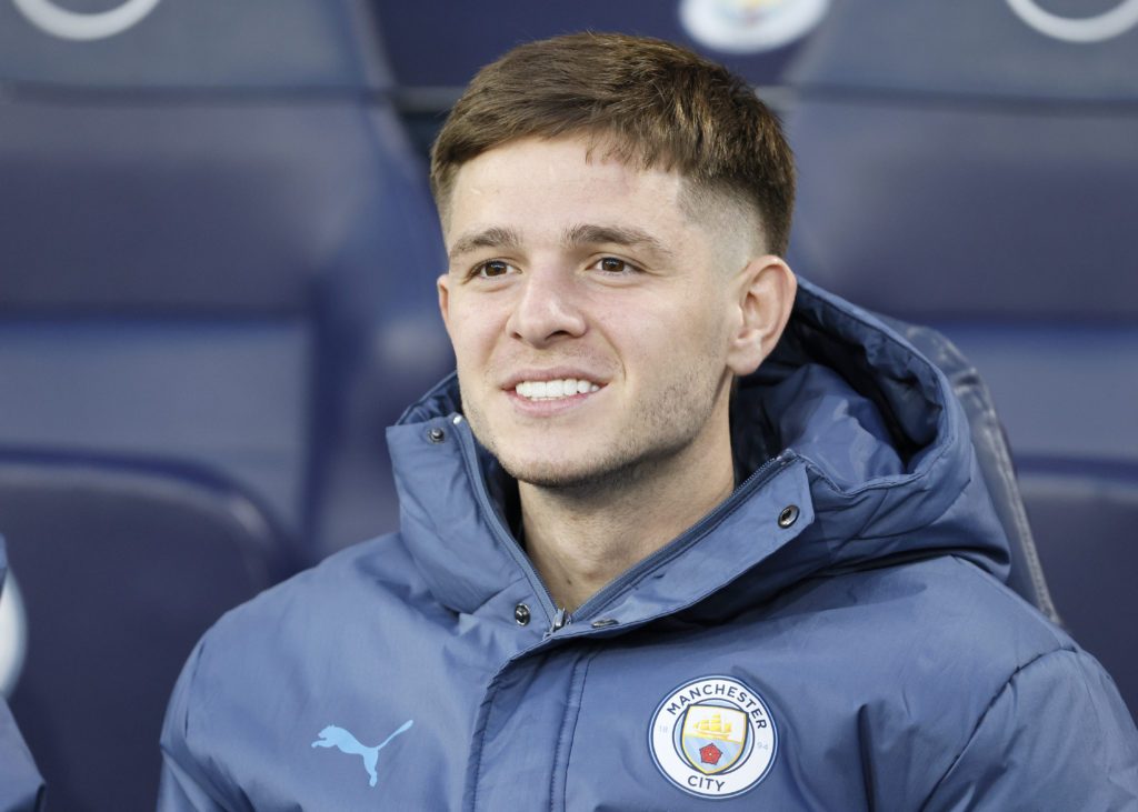 James McAtee sitting on the Manchester City bench.