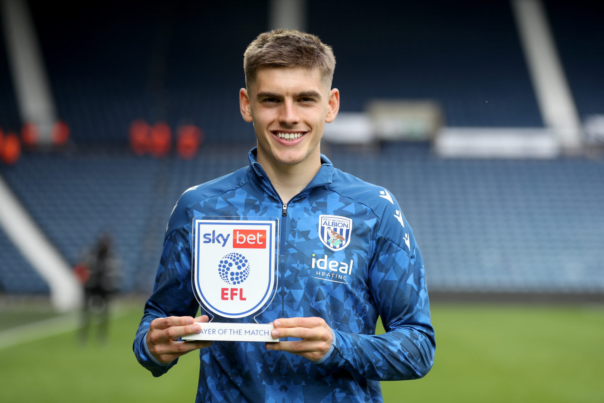 West Bromwich Albion winger Tom Fellows holding up a Championship award.