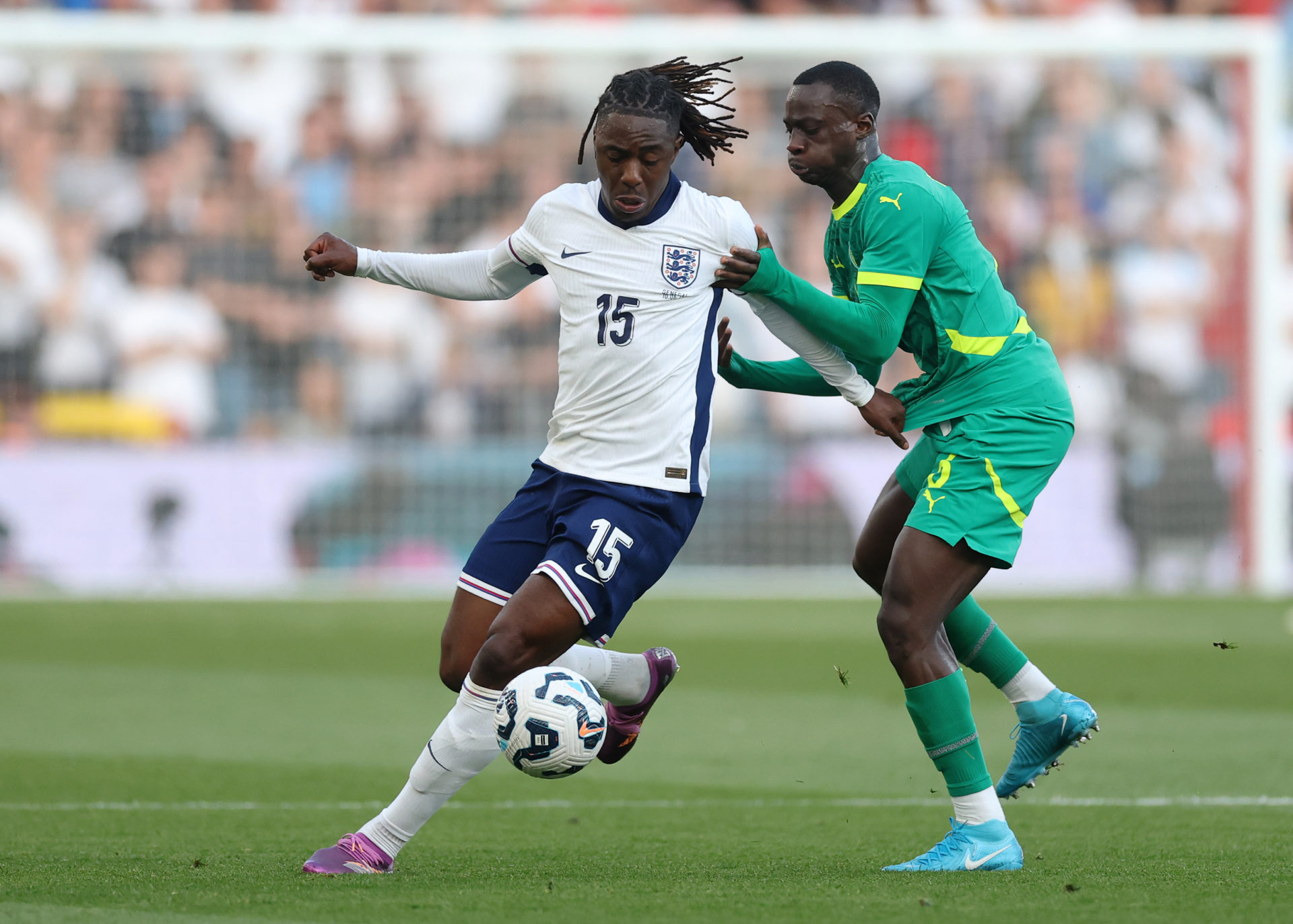 Eberechi Eze of England is challenged by Habib Diarra of Senegal.