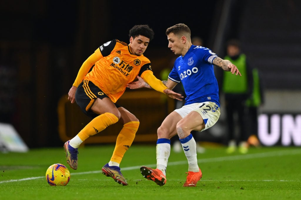Wolves' Ki-Jana Hoever challenges Everton's Lucas Digne.