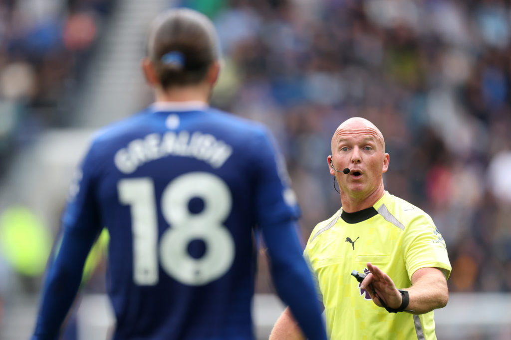 Referee Simon Hooper speaks to Jack Grealish during Everton v Aston Villa.