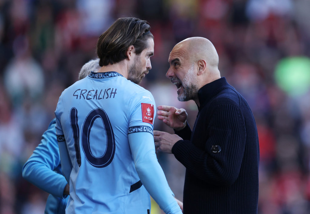 Pep Guardiola, manager/head coach of Manchester City with Jack Grealish of Manchester City during the Emirates FA Cup Quarter Final match between AFC Bournemouth and Manchester City