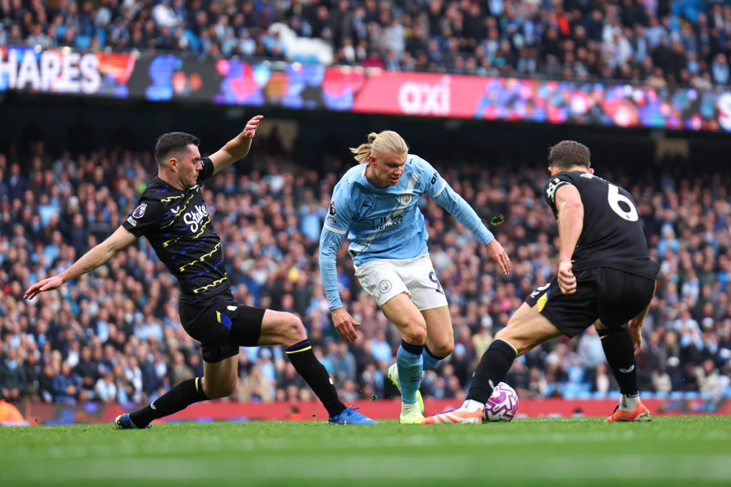 Michael Keane and James Tarkowski of Everton put Erling Haaland of Manchester City under pressure