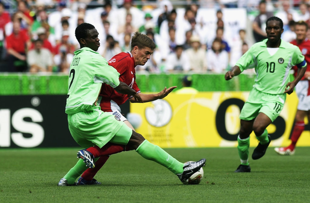 Michael Owen of England is tackled by Joseph Yobo of Nigeria