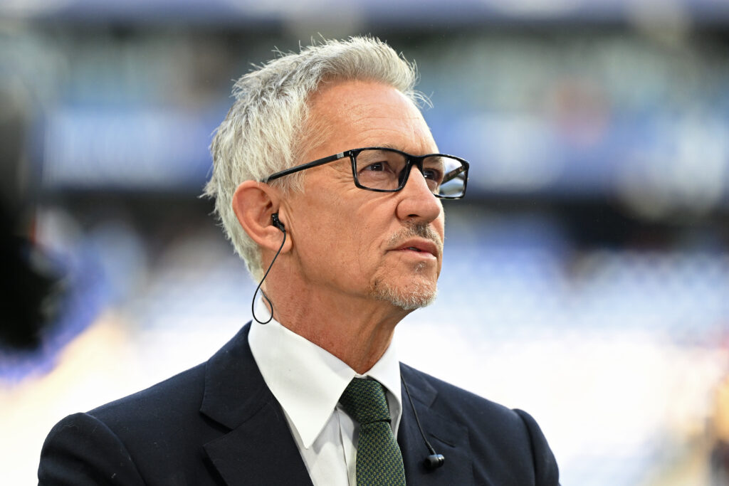 Gary Lineker looks on.