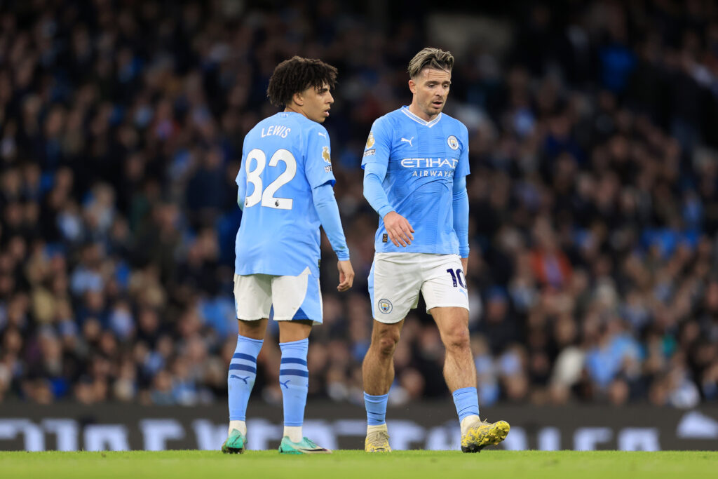 Rico Lewis and Jack Grealish playing for Manchester City.