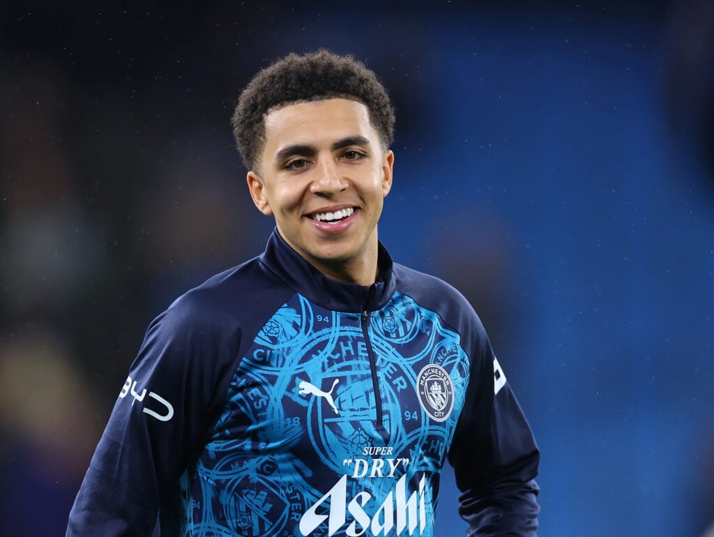 Rico Lewis warms up for Manchester City.