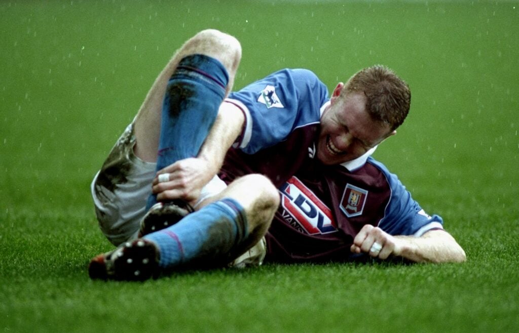 Steve Watson holds his ankle.