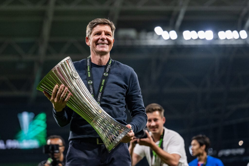 Oliver Glasner holds the Europa Conference League trophy.