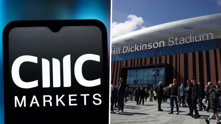 The CMC Markets logo is seen displayed on a smartphone screen. Hill Dickinson Stadium ahead of Everton v Liverpool.